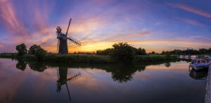 Photograph windmills at sunset